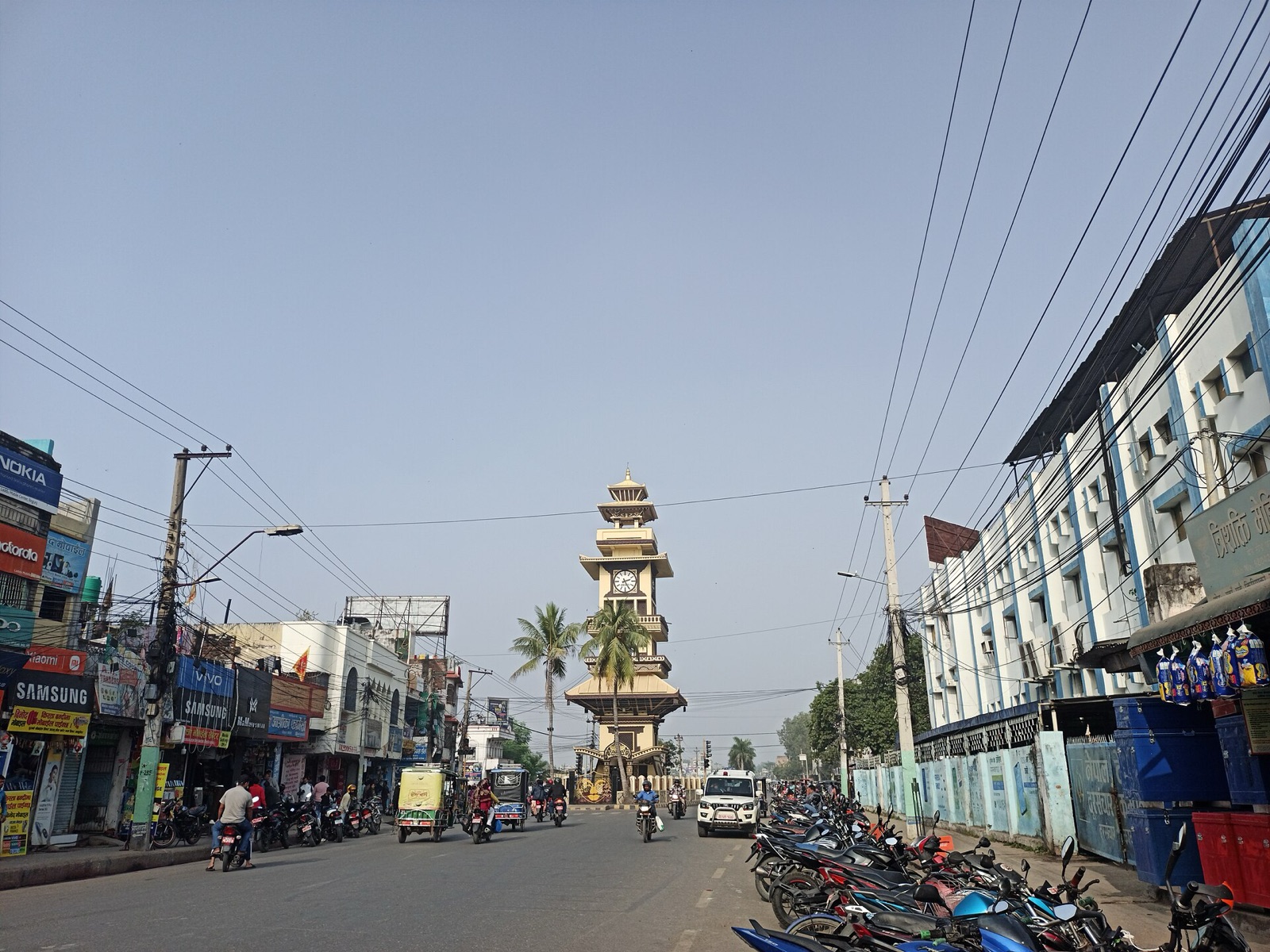 The Ghantaghar clock tower at the end of a shop-lined bazaar street in Birgunj