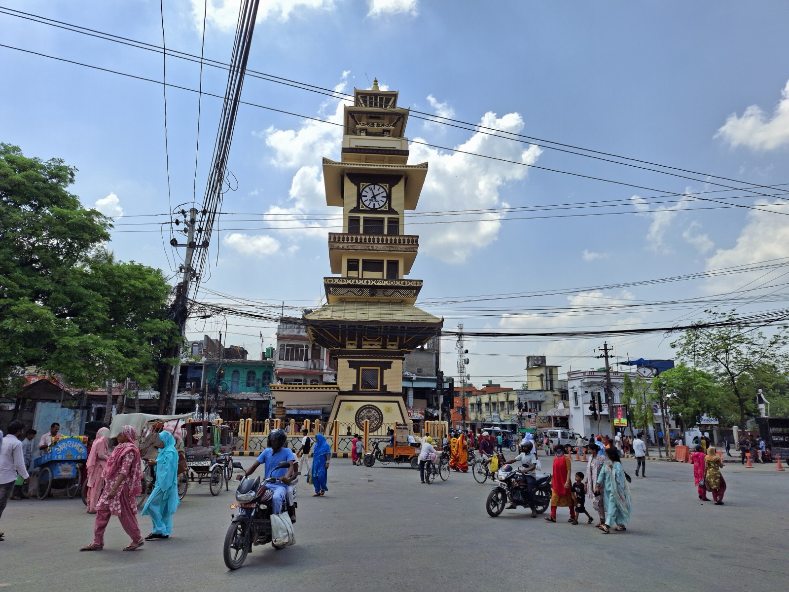 The tiered Ghantaghar clock tower at the centre of Birgunj, with rickshaws and motorbikes on the street around it