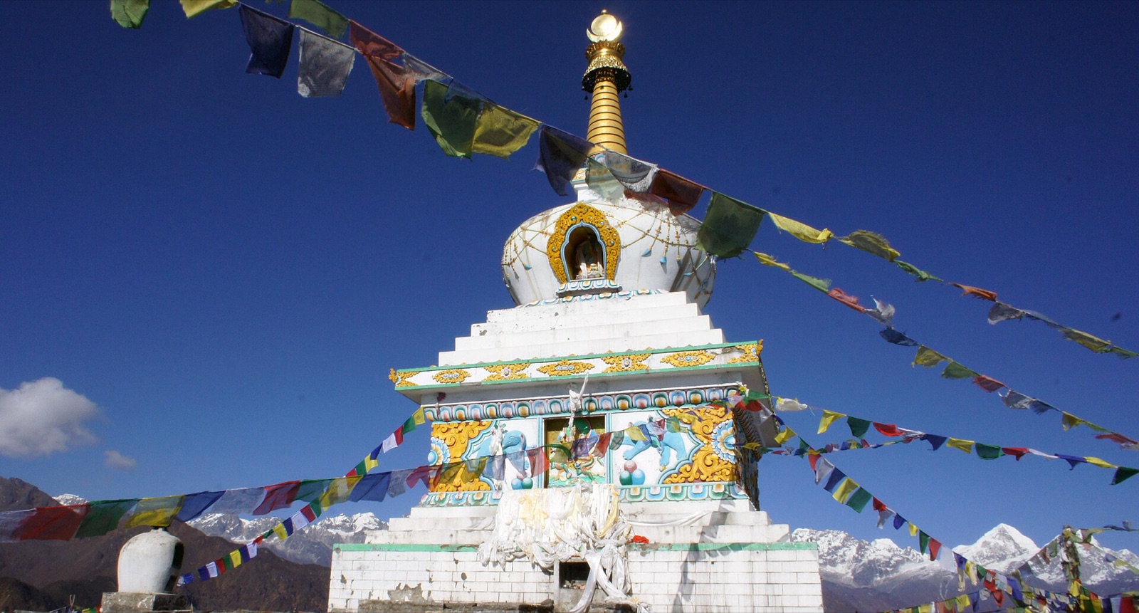 The white stupa on the Ama Yangri summit above Tarkeghyang in Helambu, with Himalayan snow peaks behind