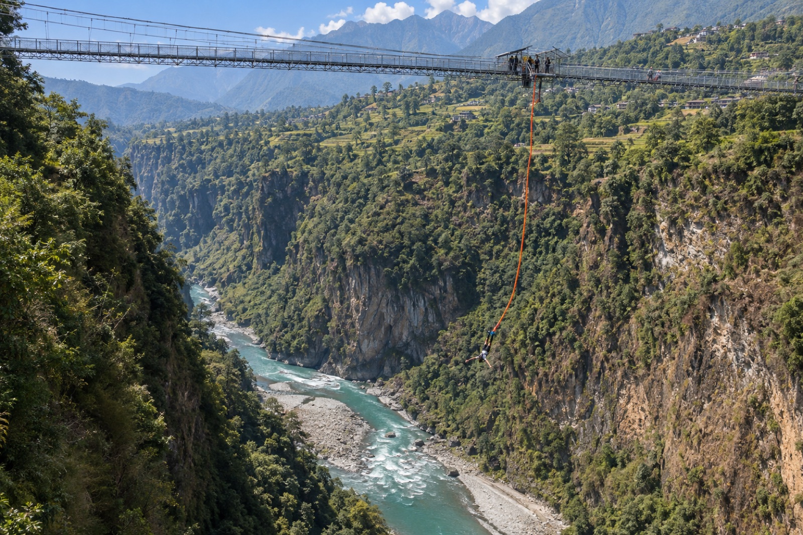 A bungee jumper falling from the bridge platform over the Kali Gandaki gorge at Kushma