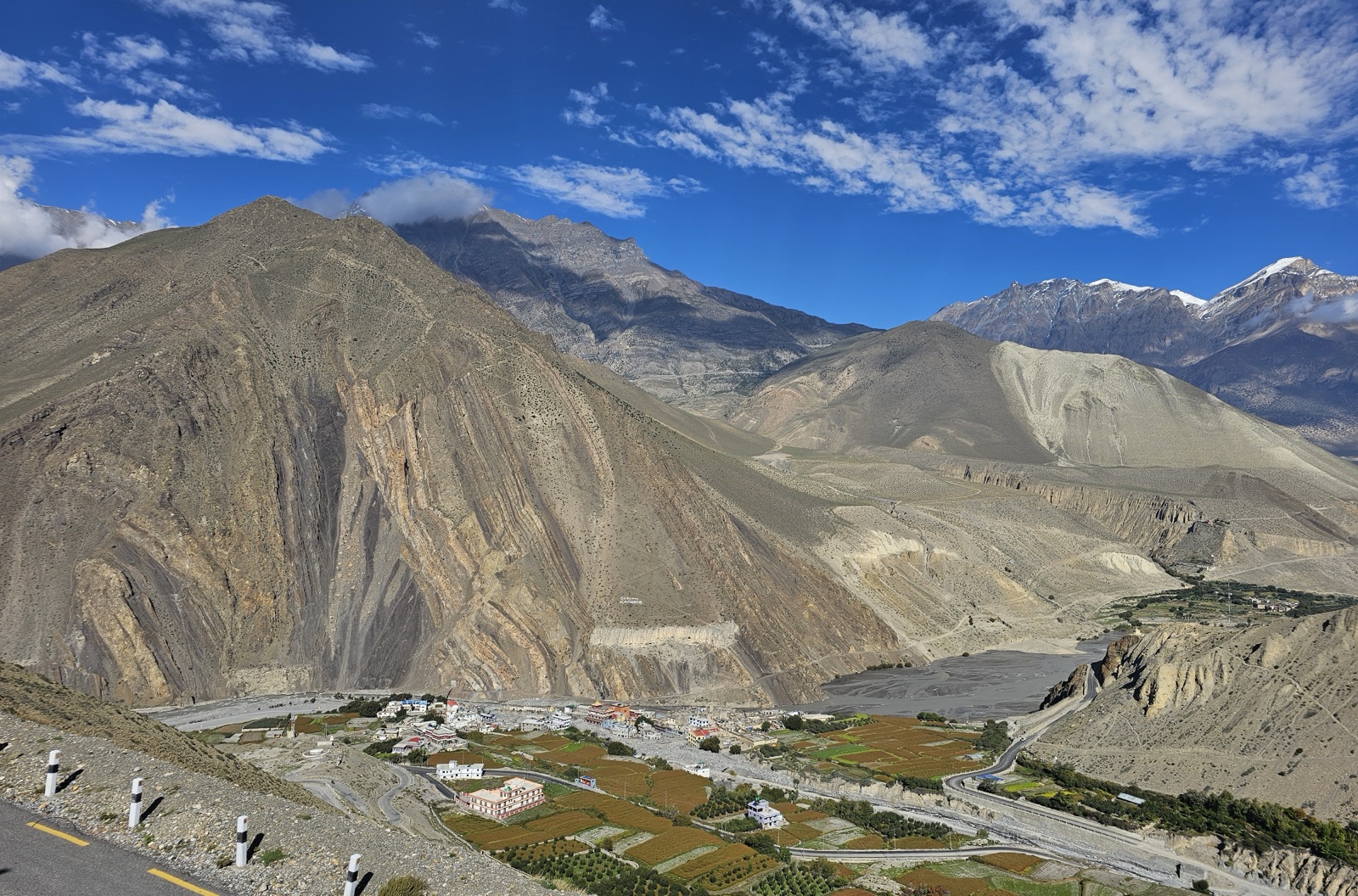 Kagbeni and its green fields beside the wide Kali Gandaki riverbed in the trans-Himalayan desert of Mustang